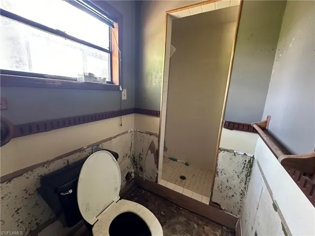 Bathroom featuring toilet and tiled shower