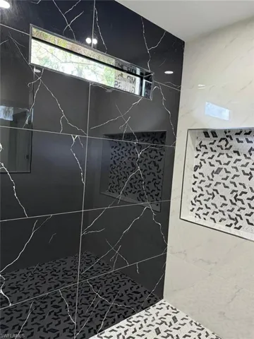 Room details featuring tiled shower