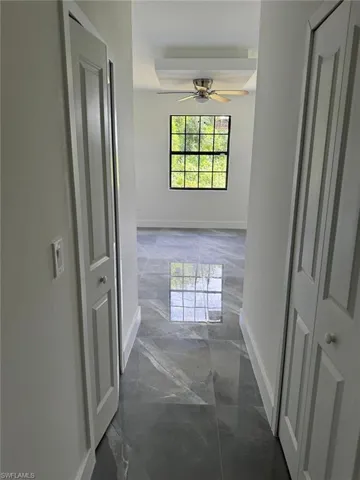 Hall with dark tile floors