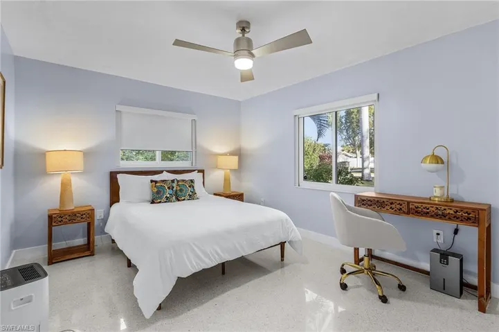Seocond Bedroom with two windows, terrazo floors, and a ceiling fan