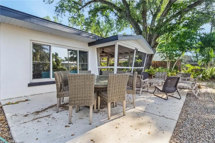 View of patio / terrace with a sunroom, fence, and outdoor dining area