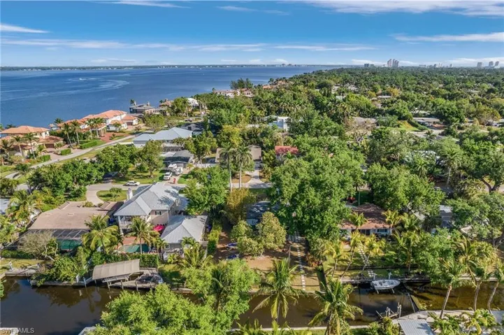 Birds eye view of property with a water view