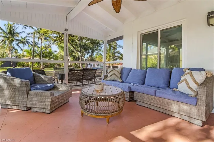View of patio / terrace with a ceiling fan and an outdoor living space, screened in lanaii