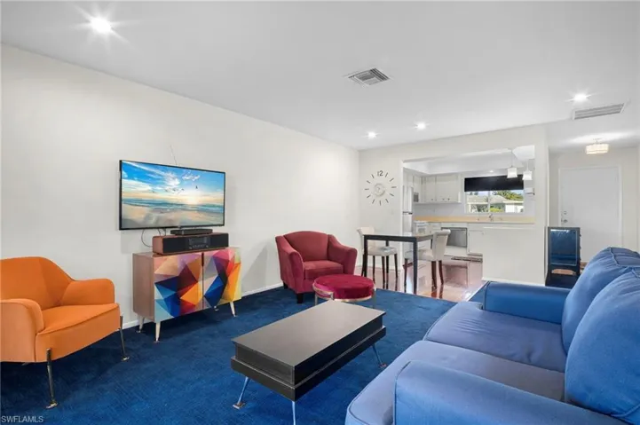 Living room with recessed lighting and baseboards