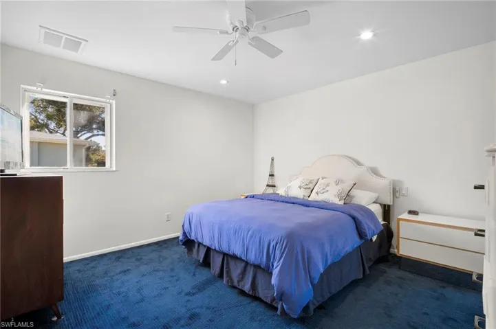 Bedroom featuring dark colored carpet, a ceiling fan, and recessed lighting