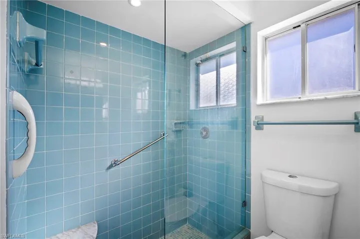 Full bath with toilet and tiled shower