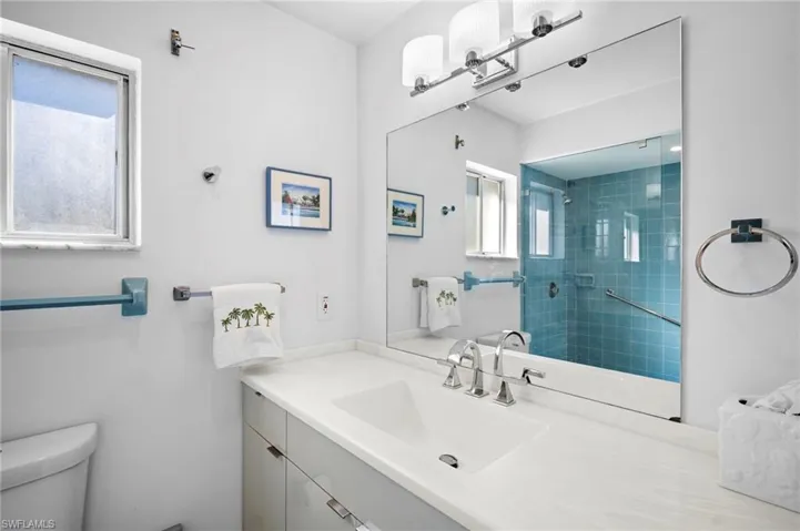 Bathroom with vanity and tiled shower
