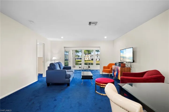 Living area with carpet and recessed lighting