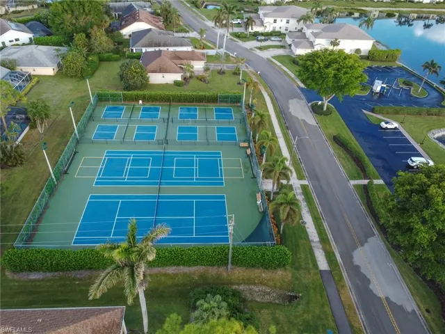 Birds eye view of property with a water view