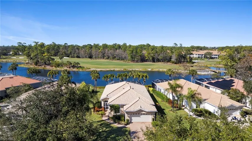Drone / aerial view of a large body of water and a golf course