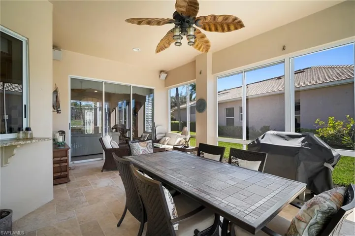 Sunroom with a ceiling fan and outdoor lounge area