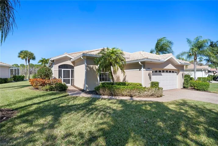 Ranch-style house featuring stucco siding, a front yard, an attached garage, and decorative driveway