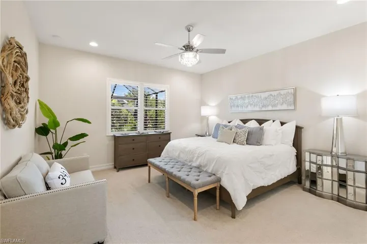 Carpeted bedroom with recessed lighting and ceiling fan