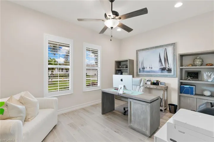 Office area with light wood-style floors, recessed lighting, and ceiling fan