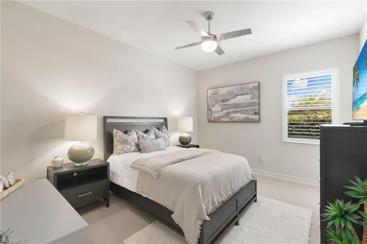 Bedroom featuring light carpet and ceiling fan