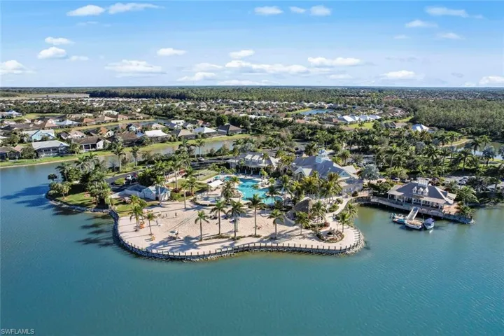 Aerial overview of property's location with nearby suburban area and a nearby body of water