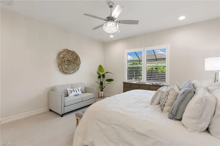 Carpeted bedroom with recessed lighting and a ceiling fan