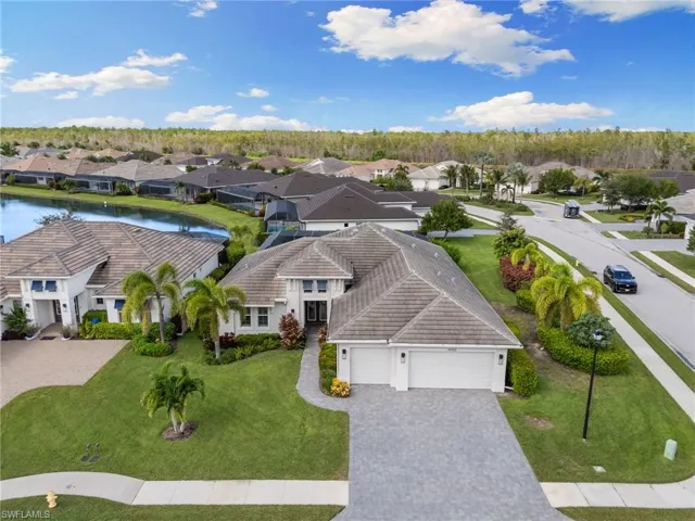 Aerial perspective of suburban area featuring a large body of water