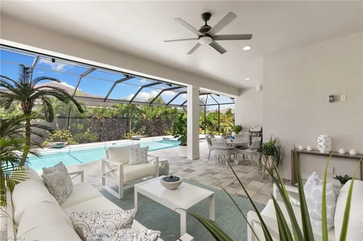 View of patio / terrace with a sunroom, a lanai, an outdoor hangout area, ceiling fan, and an outdoor pool
