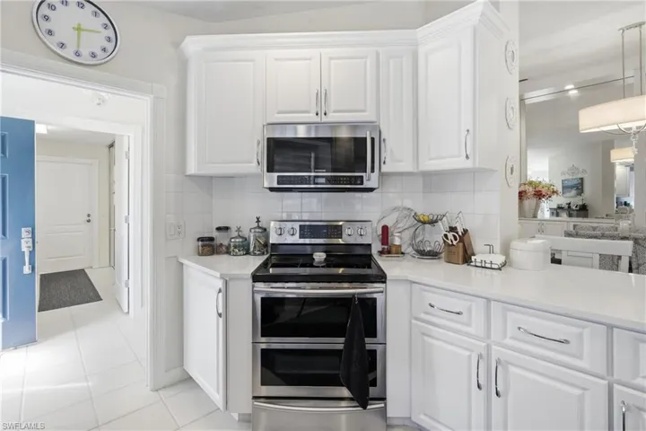 Kitchen with quartz counters, ample prep space, and open view to living area.