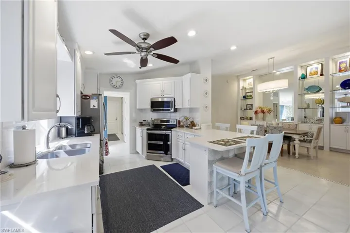 Updated kitchen featuring quartz countertops and abundant cabinetry.
