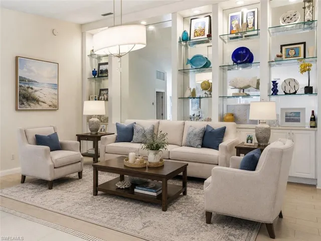 Virtually staged to show the dining room as a flexible second living area, creating a comfortable additional gathering space with coastal inspired furnishings, soft neutral tones and a balanced seating layout. This view helps highlight the room’s size, natural flow and potential for everyday living or entertaining.