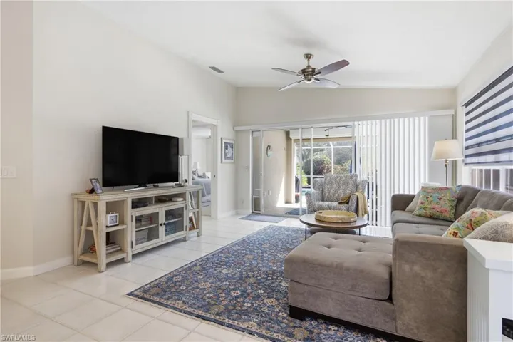 Open concept living room overlooking the lanai and private pool area.