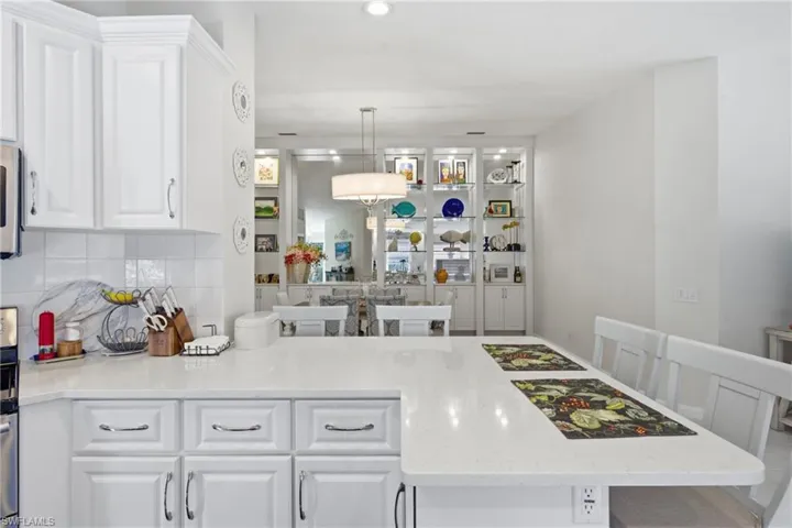 Bright kitchen with functional layout and breakfast bar seating.