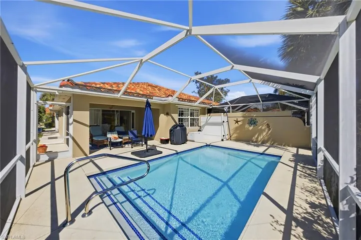 Private solar heated pool surrounded by a screened lanai creating a peaceful outdoor retreat.