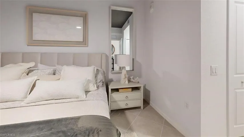 Bedroom with light tile patterned floors and baseboards