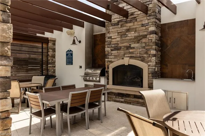 View of patio / terrace with outdoor dining space, exterior kitchen, exterior fireplace, and a pergola