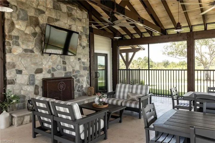 View of patio featuring ceiling fan, outdoor dining area, and an outdoor hangout area