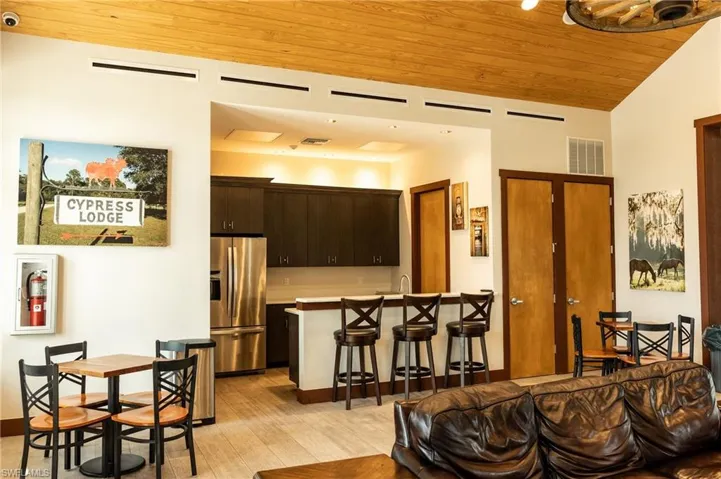 Living area featuring wooden ceiling, light wood-style floors, and vaulted ceiling