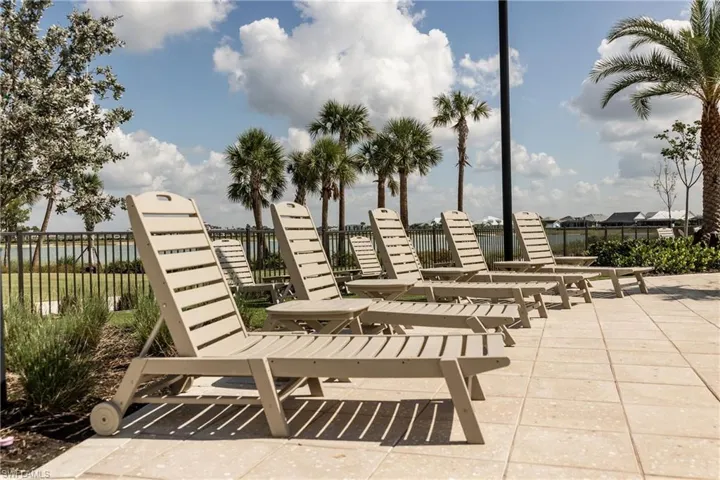 Surrounding community with a water view and a patio area