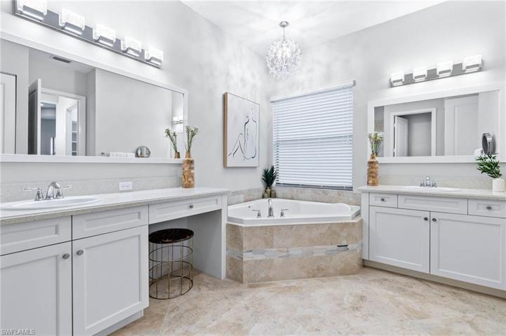 Master Bathroom with dual vanities, walk-in shower, soaking tub and water closet