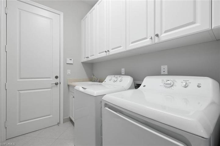 Laundry room with cabinets and wash sink