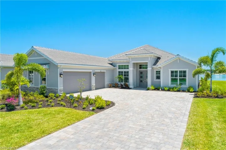 View of front of property featuring a garage and a front yard