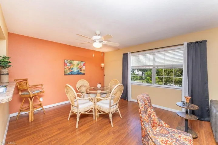 Dining room with wood finished floors and a ceiling fan