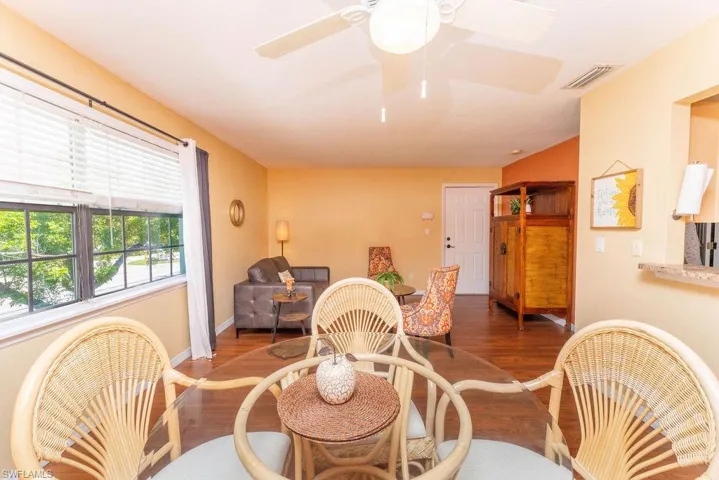 Dining space with wood finished floors and ceiling fan