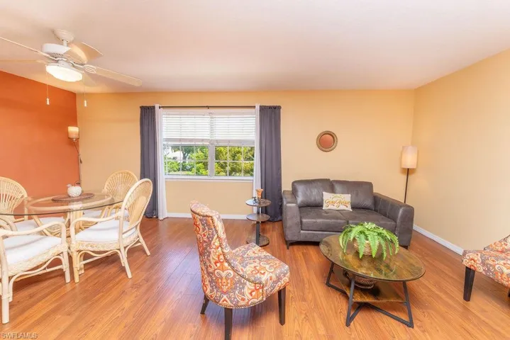 Living area with wood finished floors and ceiling fan