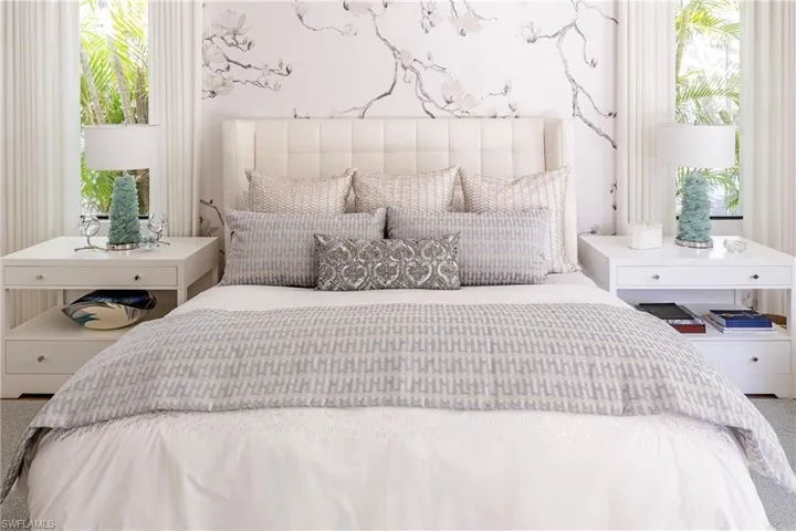 Bedroom with multiple windows and carpet