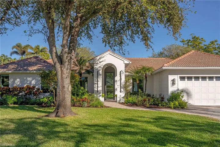 View of front of house featuring a front yard and a garage