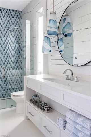 Bathroom with vanity, toilet, and walk in shower