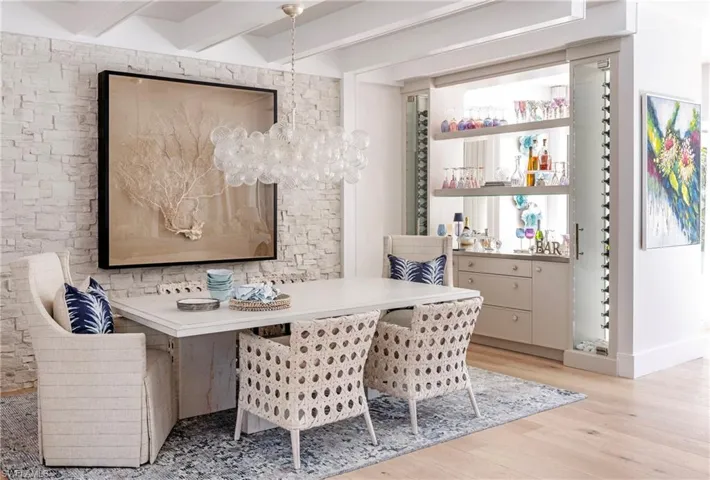 Dining space with breakfast area, beamed ceiling, and light wood-type flooring