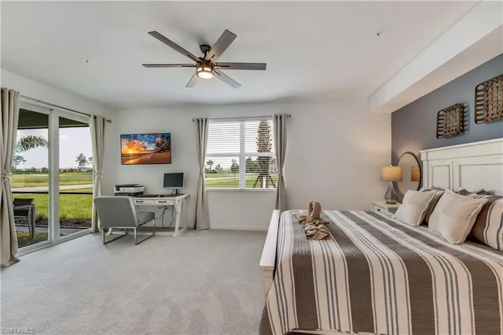 Bedroom featuring carpet, ceiling fan, and access to outside