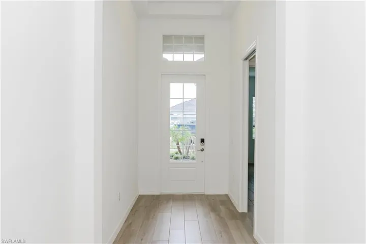 Doorway to outside with baseboards and light wood-style floors