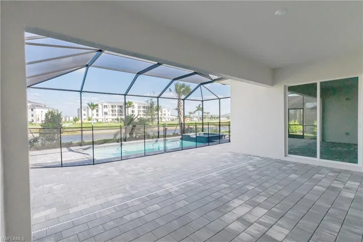 View of patio / terrace featuring a residential view, a lanai, and a pool with connected hot tub