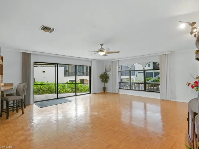 Great room with a ceiling fan, plenty of natural light, southwest exposure and ornamental molding