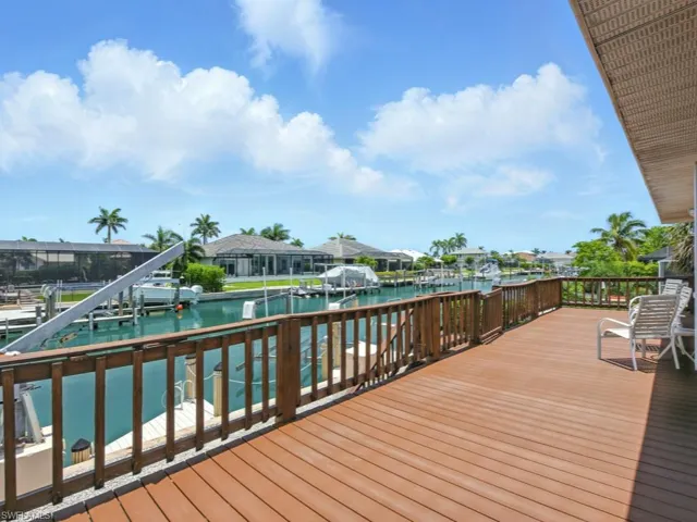 Wooden Trek deck with 12,000 lb boat lift, a water view, and southwest exposure