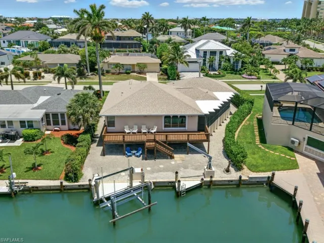 Aerial perspective of suburban area featuring a nearby body of water